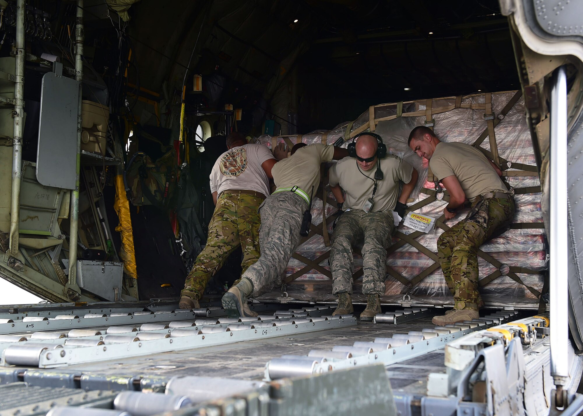 Members of the 386th Expeditionary Logistics Readiness Squadron and the 737th Expeditionary Airlift Squadron load a cargo pallet onboard a C-130H Hercules at an undisclosed location in Southwest Asia, Oct. 29, 2015. The two squadrons work together to ensure cargo is delivered safely to the correct locations throughout the area of responsibility. (U.S. Air Force photo by Staff Sgt. Jerilyn Quintanilla)