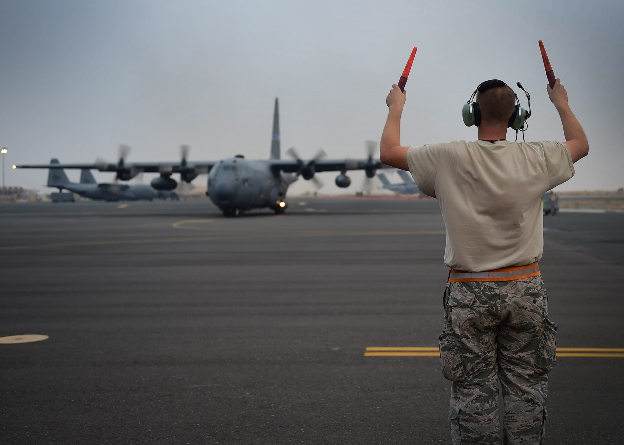 Staff Sgt. Slade Hall, 386th Expeditionary Aircraft Maintenance Squadron crew chief, marshals a C-130H Hercules for takeoff at an undisclosed location in Southwest Asia, Oct. 29, 2015. Crew chiefs are responsible for maintaining fully mission capable aircraft. They must perform inspections, launch and recover aircraft, and ensure aircraft maintenance is completed. (U.S. Air Force photo by Staff Sgt. Jerilyn Quintanilla)