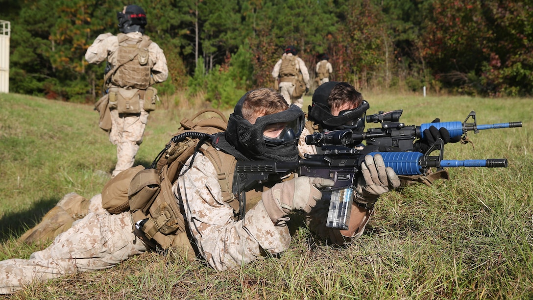 Two Marines with 1st Battalion, 6th Marine Regiment maintain security during the Basic Urban Skills Training course at Marine Corps Base Camp Lejeune, N.C., Oct. 30, 2015. The BUST Course trains Marines to perform multiple combat operations on urban environments. 