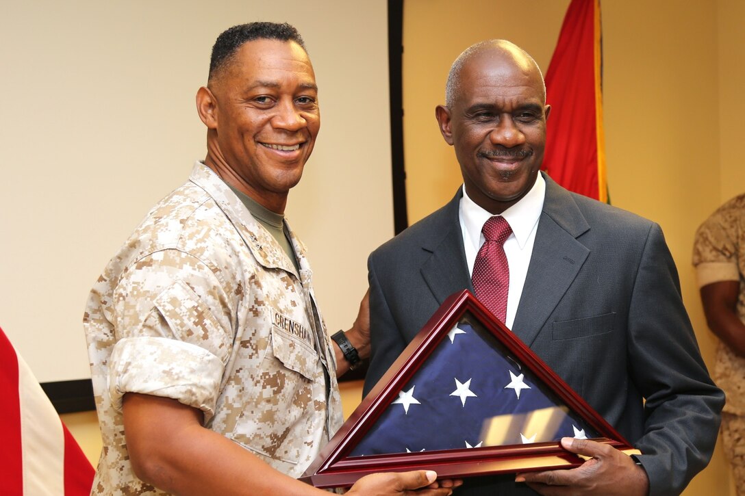 Major General Craig C. Crenshaw, Commanding General, LOGCOM, presents Mr. Ivy Hines with a flag that was flown at LOGCOM Headquarters in his honor, during a retirement ceremony on 29 October, 2015.  Mr. Hines had over 32 years of federal service. 