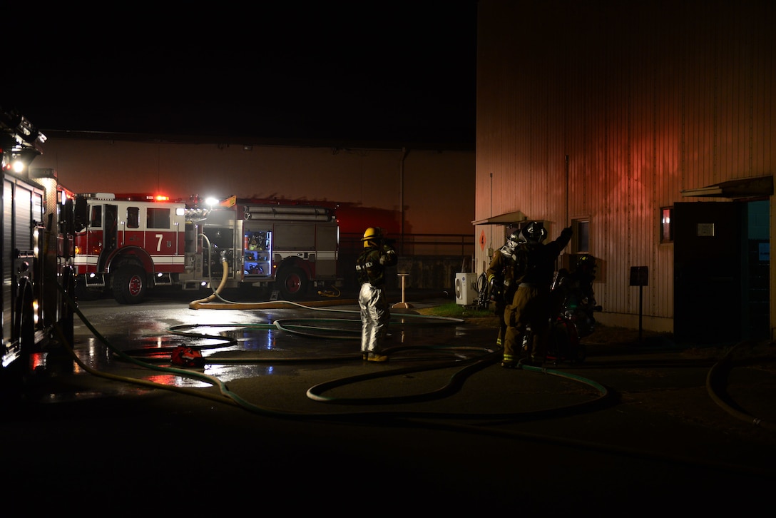 U.S. airmen respond to a simulated burning building during Vigilant Ace 16 on Osan Air Base, South Korea, Nov. 3, 2015. The airmen are firefighters assigned to the 51st Civil Engineer Squadron. U.S. Air Force photo by Staff Sgt. Amber Grimm