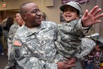 Staff Sgt. Antonio Nieto, 50th Personnel Services Battalion, New Jersey Army National Guard, laughs with his daughter Antonella after returning from a year-long tour in Afghanistan in support of Operation Enduring Freedom March 2, 2007, at Joint Base McGuire Dix-Lakehurst, New Jersey. November honors military families and the sacrifices they make.