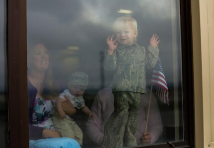 A one-year old boy patiently awaits the arrival of his father, Master Sgt. Lucas Yuill, of the 210th Rescue Squadron, Alaska Air National Guard, at the Joint Mobility Complex on Joint Base Elmendorf-Richardson, June 3. Yuill was returning from a 4-month deployment to the Horn of Africa in support of Operation Enduring Freedom. Military families are singled out for recognition during November.