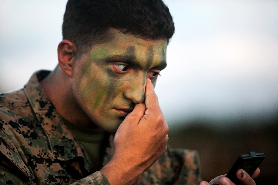 U.S. Marine Corps Cpl. Michael B. Wheeler applies camouflage paint on Camp Hansen, Okinawa, Japan, Oct. 31, 2015, to prepare for an air assault during Blue Chromite 2016. Wheeler is assigned to the 2nd Marine Division's 1st Battalion, 2nd Marine Regiment, 2nd Marine Expeditionary Force. The large-scale amphibious exercise draws primarily from 3rd Marine Expeditionary Force’s training resources on Okinawa. U.S. Marine Corps photo by Cpl. Drew Tech 