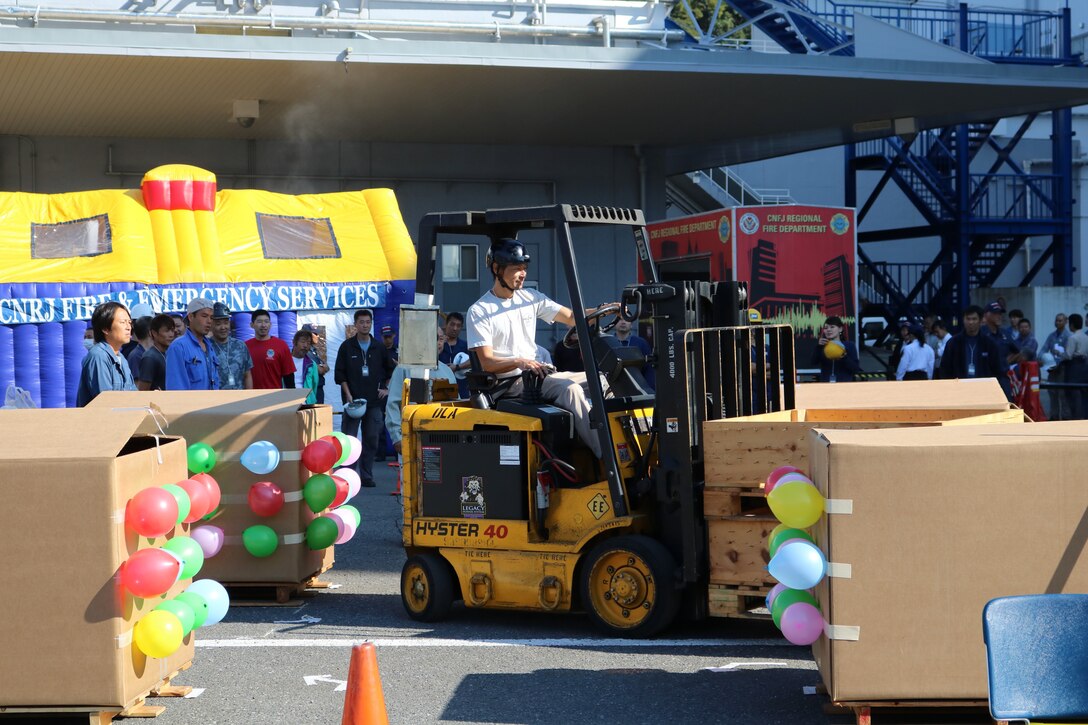 Participants in DLA Distribution Yokosuka’s Forklift Rodeo drive through a course designed to test their skills.