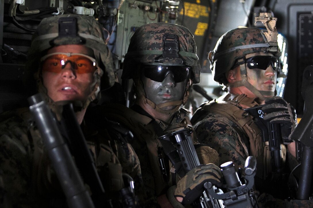 U.S. Marine Corps Cpl. Tyler Willis, left, U.S. Marine Corps Lance Cpl. Adam Gentilin, center, and U.S. Marine Corps Cpl. Michael B. Wheeler ride in an MV-22B Osprey over Okinawa, Japan, Oct. 31, 2015, while conducting an air assault during Blue Chromite 2016. Willis, Gentilin and Wheeler are assigned to the 2nd Marine Division's 1st Battalion, 2nd Marine Regiment, 2nd Marine Expeditionary Force. U.S. Marine Corps photo by Cpl. Drew Tech


