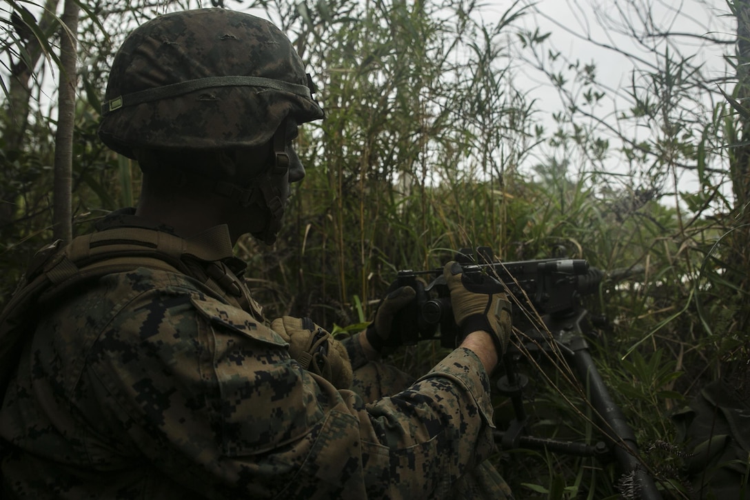 U.S. Marine Corps Lance Cpl. Adam Gentilin provides security while manning a M2 .50-caliber Browning machine gun in the Jungle Warfare Training Area, Okinawa, Japan, Oct. 31, 2015, as part of an air assault during Blue Chromite 2016. Gentilin is a machine gunner assigned to the 2nd Marine Division's 1st Battalion, 2nd Marine Regiment, 3rd Marine Expeditionary Force. U.S. Marine Corps photo by Cpl. Drew Tech