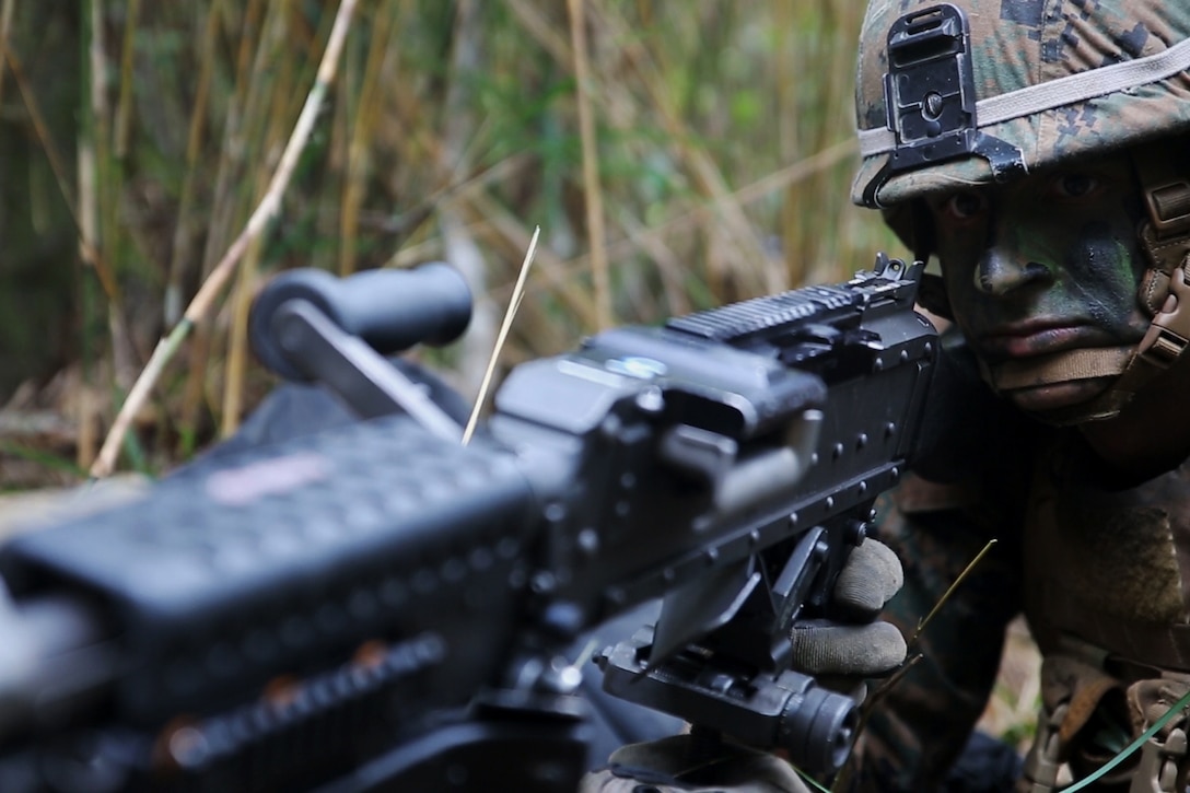 A U.S. Marine provides security while manning a M240B medium machine gun in the Jungle Warfare Training Area, Okinawa, Japan, Oct. 31, 2015, as part of a regimental air assault during Blue Chromite 2016. U.S. Marine Corps photo by Cpl. Drew Tech 