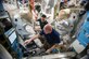 Astronauts Scott Kelly, front, and Kjell Lindgren, a 1995 Air Force Academy graduate, prepare their extravehicular mobility unit spacesuits and tools in the Quest airlock of the International Space Station. Kelly and Lindgren will use the spacesuits for a spacewalk outside the station Nov. 6, 2015. (NASA courtesy photo)
