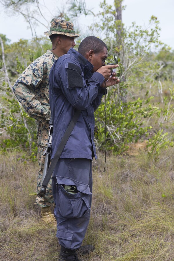 U.S. Marine Corps Cpl. Jorge Flores, squad advisor, Special Purpose Marine Air-Ground Task Force-Southern Command advises Seaman Apprentice Andrew Caine, Belize Coast Guard, during a field exercise in Ladyville, Belize, Sept. 29, 2015. SPMAGTF-SC is a temporary deployment of Marines and Sailors throughout Honduras, El Salvador, Guatemala, and Belize with a focus on building and maintaining partnership capacity with each country through shared values, challenges, and responsibilities. (U.S. Marine Corps photo by Cpl. Shakeasha  J. Payton/Released)