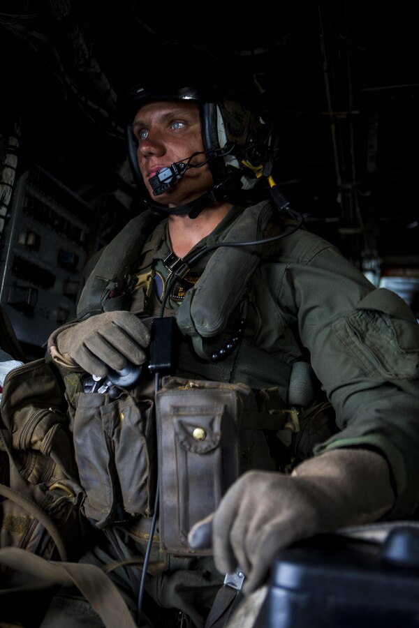 U.S. Marine Corps Lance Cpl. Jacy Connell, a CH-53 Super Stallion flight crewman, and Derry, N.H., native, with Special Purpose Marine Air-Ground Task Force-Southern Command watches as the CH-53 Super Stallion leaves the ground from Puerto Lempira, Honduras, Oct. 6, 2015. SPMAGTF-SC is a temporary deployment of Marines and Sailors throughout Honduras, El Salvador, Guatemala, and Belize with a focus on building and maintaining partnership capacity with each country through shared values, challenges, and responsibility. (U.S. Marine Corps Photo by Cpl. Katelyn Hunter/Released)