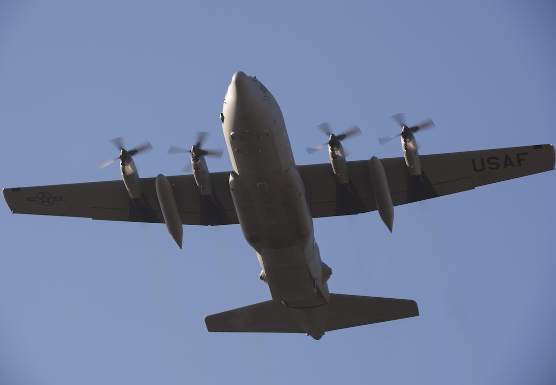 A C-130H Hercules aircraft flies to a drop zone during Aviation Detachment 16-1 on Powidz Air Base, Poland, Oct. 27, 2015. The Hercules crew is assigned to the 169th Airlift Squadron. U.S. Air Force photo by Senior Airman Damon Kasberg