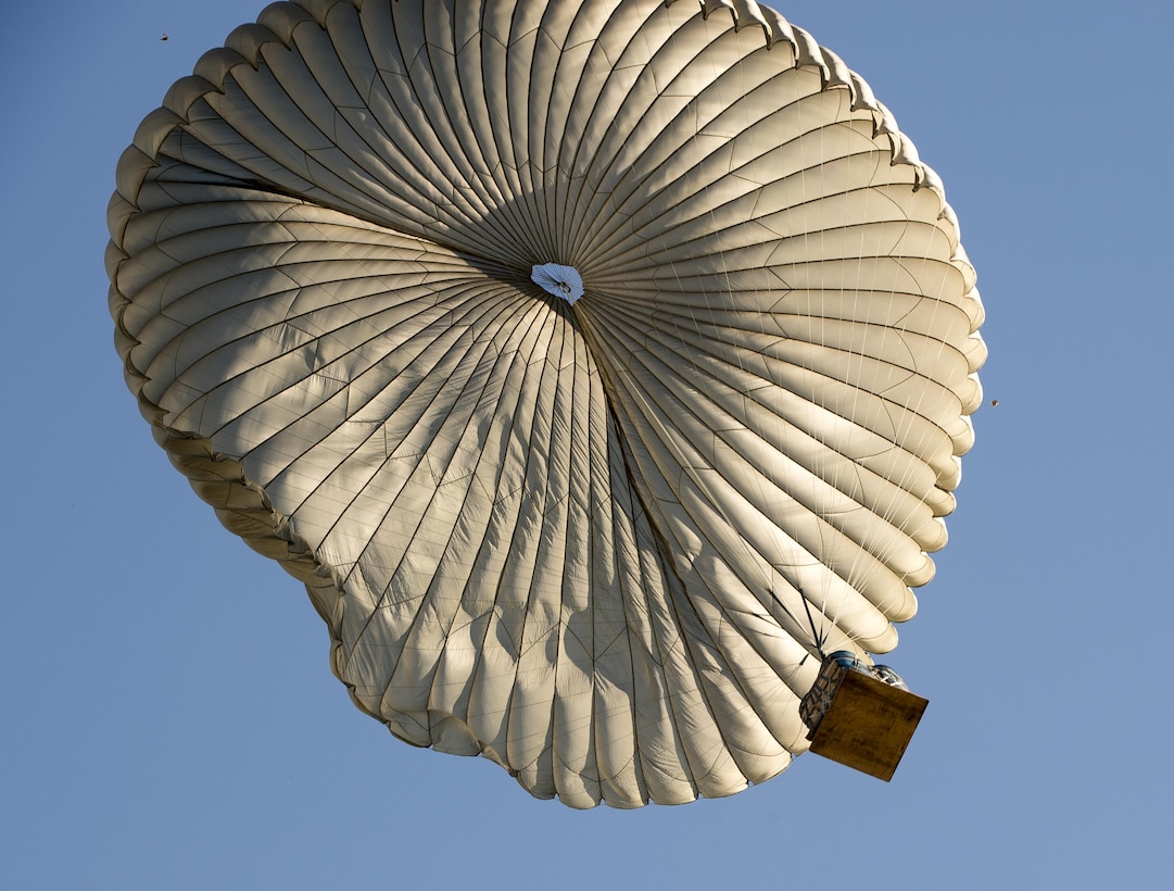 A container delivery system parachutes toward the drop zone during Aviation Detachment 16-1 on Powidz Air Base, Poland, Oct. 27, 2015. U.S. Air Force photo/Senior Airman Damon Kasberg
