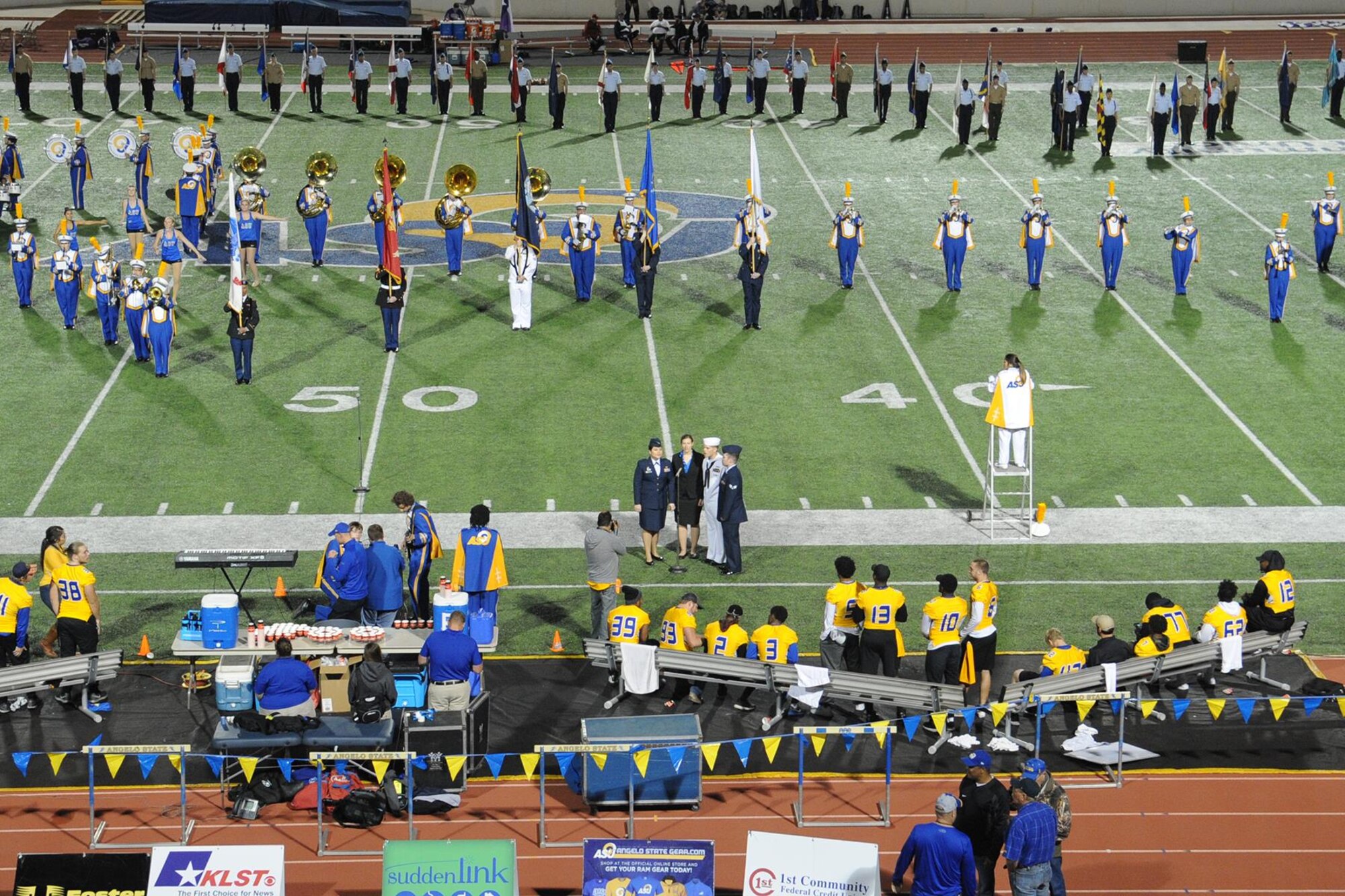 Patriotic Blue sings Lee Greenwood’s “God Bless the USA” as the Angelo State University marching band performs during ASU’s Military Appreciation Day football game half-time show at the LeGrand Stadium, San Angelo, Texas, Oct. 31, 2015. ASU and local groups sponsored several events to show their appreciation to all active duty and retired military personnel and their families during the day. (U.S. Air Force photo by Staff Sgt. Laura R. McFarlane/Released)