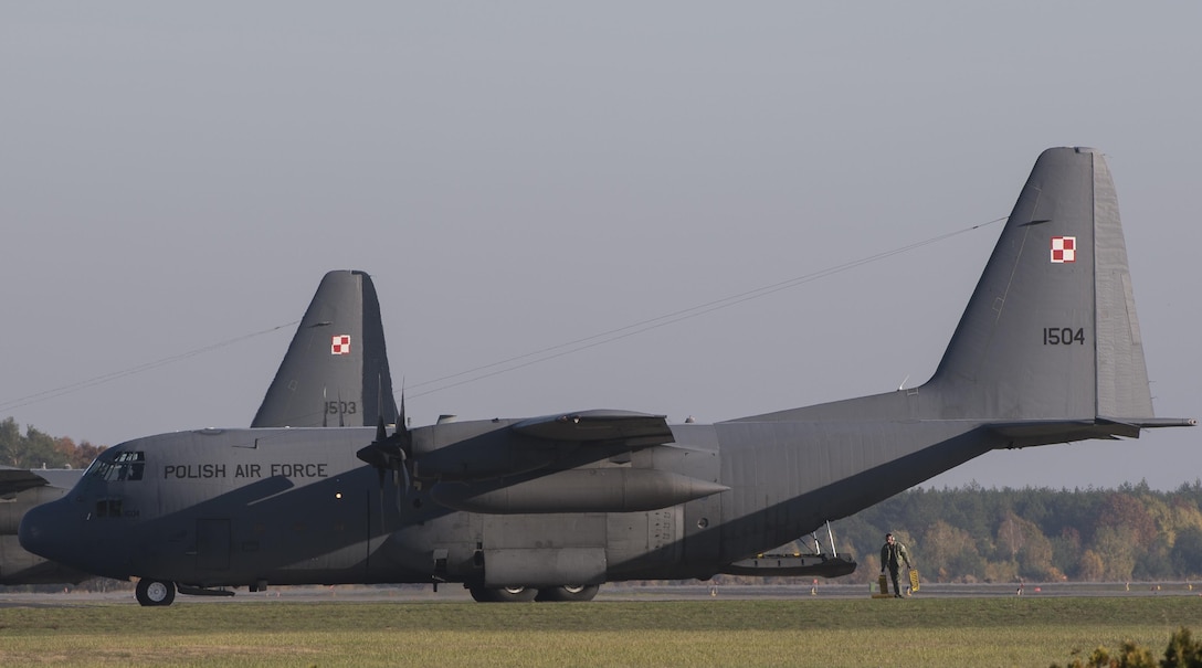 Polish airmen park a C-130E Legacy aircraft after completing a five-ship-formation flight during Aviation Detachment 16-1 on Powidz Air Base, Poland, Oct. 27, 2015. U.S. Air Force photo by Senior Airman Damon Kasberg 