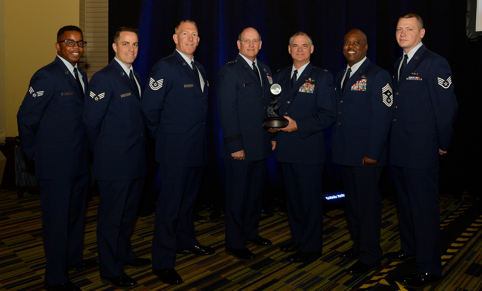 Lt. Gen. James F. Jackson, chief of the Air Force Reserve and commander, Air Force Reserve Command, poses with 302nd Airlift Wing commander, Col. Jay Pittman and 302nd AW Command Chief Master Sgt. Otis Jones, during the Lt. Gen. James E. Sherrard III Award presentation at the 47th Annual Air Mobility Command and Airlift/Tanker Association Symposium in Orlando, Fla., Oct. 31. The 302nd AW was recognized for its overall contributions to the Mobility Air Force mission and total force. Outstanding performers selected by 302nd AW leadership to represent the wing (left to right) are: Senior Airmen Howard Smith and Matthew Kenny, Tech. Sgt. Christopher Meyer, (Lt. Gen. James F. Jackson, Col. Jay Pittman, Chief Master Sgt. Otis Jones) and Staff Sgt. Curtis LeMay. 