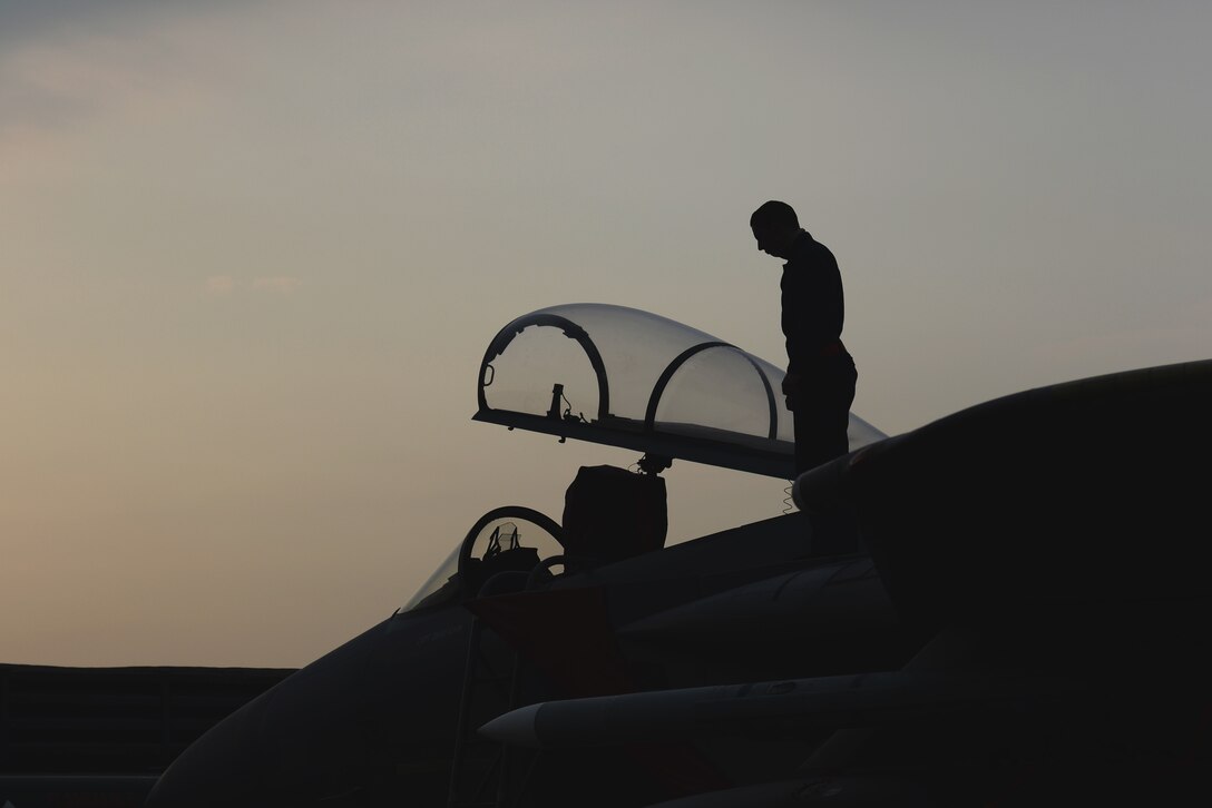Senior Airman Maxwell Seley, 67th Fighter Squadron Aircraft Maintenance Unit crew chief, inspects the topside of an F-15 Eagle after it arrives from Kadena Air Base, Japan, in support of Vigilant Ace 16 on Gwangju Air Base, Nov. 2, 2015. Vigilant Ace 16 is a regularly scheduled training event designed to enhance the readiness of U.S. and Republic of Korea forces. (U.S. Air Force photo/Senior Airman Omari Bernard)