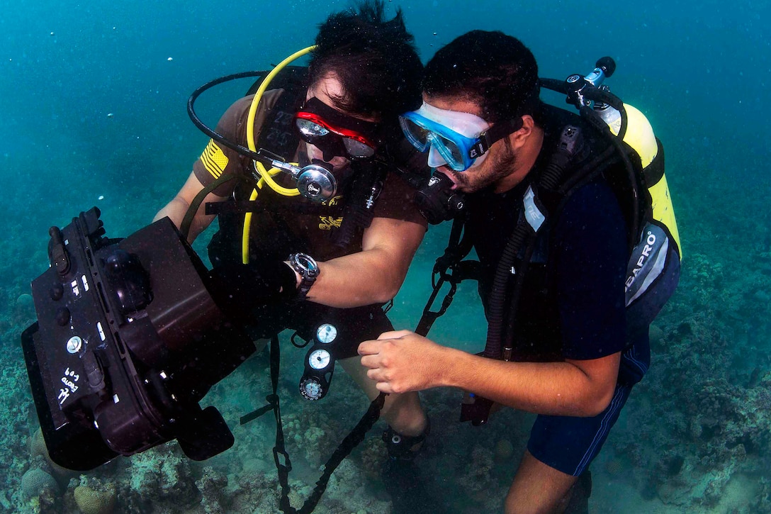 U.S. Navy Petty Officer 2nd Class Justin Kwon and a member of the Bahraini coast guard conduct searches using an underwater imaging system on Naval Support Activity Bahrain, Oct. 28, 2015. Kwon is assigned to Commander, Task Group 56.1. Commander Task Group 56.1 conducts mine countermeasures, explosive ordnance disposal, salvage-diving and force protection operations throughout the U.S. 5th Fleet area of operations. U.S. Navy photo by Petty Officer 2nd Class Wyatt Huggett