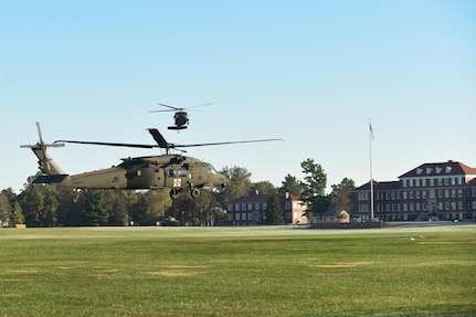 A HH-60 medevac helicopter from Fox Company 1-214th Aviation Regiment and a UH-60 Black Hawk helicopter from 8-229th Assault Helicopter Battalion come to a hover Oct. 18 at Brooks Field, Fort Knox, Ky. These aircraft were being prepositioned as a static display for the 11th Theater Aviation Command’s Change of Responsibility Ceremony. Command Sgt. Maj. James Peter Matthews took the helm as the senior enlisted soldier from Command Sgt. Maj. Steven Hatchell. The 11th Theater Aviation Command (TAC) is the only aviation command in the Army Reserve. The 11th TAC has two missions, functioning as both a warfighting headquarters and as a functional command. As warfighting command, the 11th TAC provides command & control, staff planning, and supervision for two aviation brigades and one air traffic service battalion. As a functional command the 11th TAC provides command and control for all Army Reserve Aviation. (Photos by Renee Rhodes / Fort Knox Visual Information)