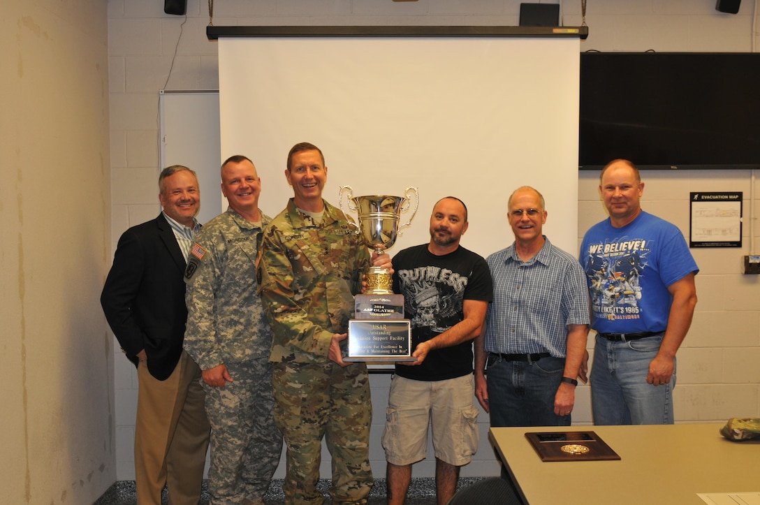 Pictured from left to right are 11th Theater Aviation Command Aviation Program Manager Wiley Gustafson, 11th Theater Aviation Commander Brig. Gen. Scott Morcomb, USARC Deputy Commanding General of Operations Maj. Gen. David Conboy, aircraft mechanic Robert Holder, ASF supervisor Bric Lewis and Deputy Aviation Program Manager Michael Walsh. Holder and Lewis received the Reserve Officers Association’s (ROA’s) Outstanding USAR Aviation Support Facility Award from Conboy on behalf of all the soldiers and civilians of Aviation Support Facility (ASF) Olathe on Oct. 19 in New Century, Kan. ASF Olathe is one of the 17 ASFs under command and control of the 11th Theater Aviation Command (TAC). The 11th TAC is the only aviation command in the U.S. Army Reserve and has over 4,200 soldiers, 700 civilians and 190 aircraft dispersed across 13 different states. (U.S. Army Photo by Capt. Matthew Roman, 11th Theater Aviation Command Public Affairs Officer)