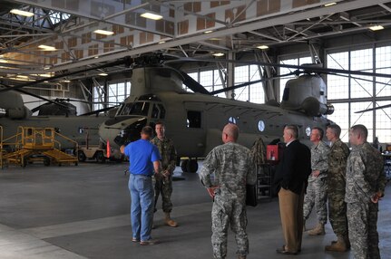 Deputy Aviation Program Manager Michael Walsh gives Maj. Gen. David Conboy, USARC deputy commanding general of operations, a tour of Aviation Support Facility (ASF) Olathe during a site visit Oct. 19 in New Century, Kan. ASF Olathe has received the 2014 Reserve Officers Association’s (ROA’s) Outstanding USAR Aviation Support Facility Award. The Outstanding USAR Aviation Support Facility Award is intended to recognize the top ASF in the U.S. Army Reserve and ASF Olathe edged out the other 16 ASFs to earn the 2014 crown. ASF Olathe is one of the 17 ASFs under command and control of the 11th Theater Aviation Command (TAC). The 11th TAC is the only aviation command in the U.S. Army Reserve and has over 4,200 soldiers, 700 civilians and 190 aircraft dispersed across 13 different states. (U.S. Army Photo by Capt. Matthew Roman, 11th Theater Aviation Command Public Affairs Officer)