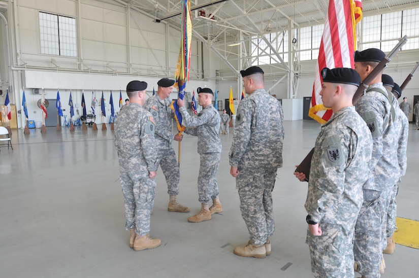 Lt. Col. Geoffrey Jeram assumed command of 2-228th Aviation Regiment in a ceremony at its headquarters located on Joint Base McGuire-Dix-Lakehurst, Sunday, Aug. 9. In his first official act as incoming commander, Jeram received the battalion colors from by Col. William Clark, 244th Aviation Brigade Commander. (U.S. Army Photo by Capt. Matthew Roman, 11th Theater Aviation Command Public Affairs Officer)