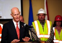 Florida Gov. Rick Scott speaks during a ceremony celebrating the completion of the U.S. 98/Cody Avenue interchange at Hurlburt Field, Fla., Nov. 2, 2015. The project elevated the U.S. 98 travel lanes above Cody Avenue to create a grade-separated interchange where traffic destined for Hurlburt accesses the gate via on- and off- ramps. (U.S. Air Force photo by Senior Airman Meagan Schutter/Released)