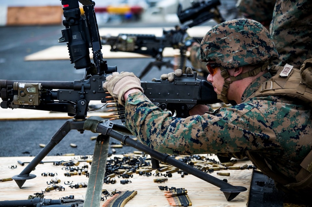 INDIAN OCEAN (Oct. 3, 2015) U.S. Marine Lance Cpl. Corey Johnson reloads an M240B machine gun during a deck shoot aboard the amphibious assault ship USS Essex (LHD 2). Johnson is a scout with Scout Sniper Platoon, Weapons Company, Battalion Landing Team 3rd Battalion, 1st Marine Regiment, 15th Marine Expeditionary Unit. The Marines practiced firing machine guns to enhance their marksmanship on ship. The 15th MEU is currently deployed in the Indo-Asia-Pacific region to promote regional stability and security in the U.S. 7th Fleet area of operations. (U.S. Marine Corps photo by Sgt. Anna Albrecht/ Released)