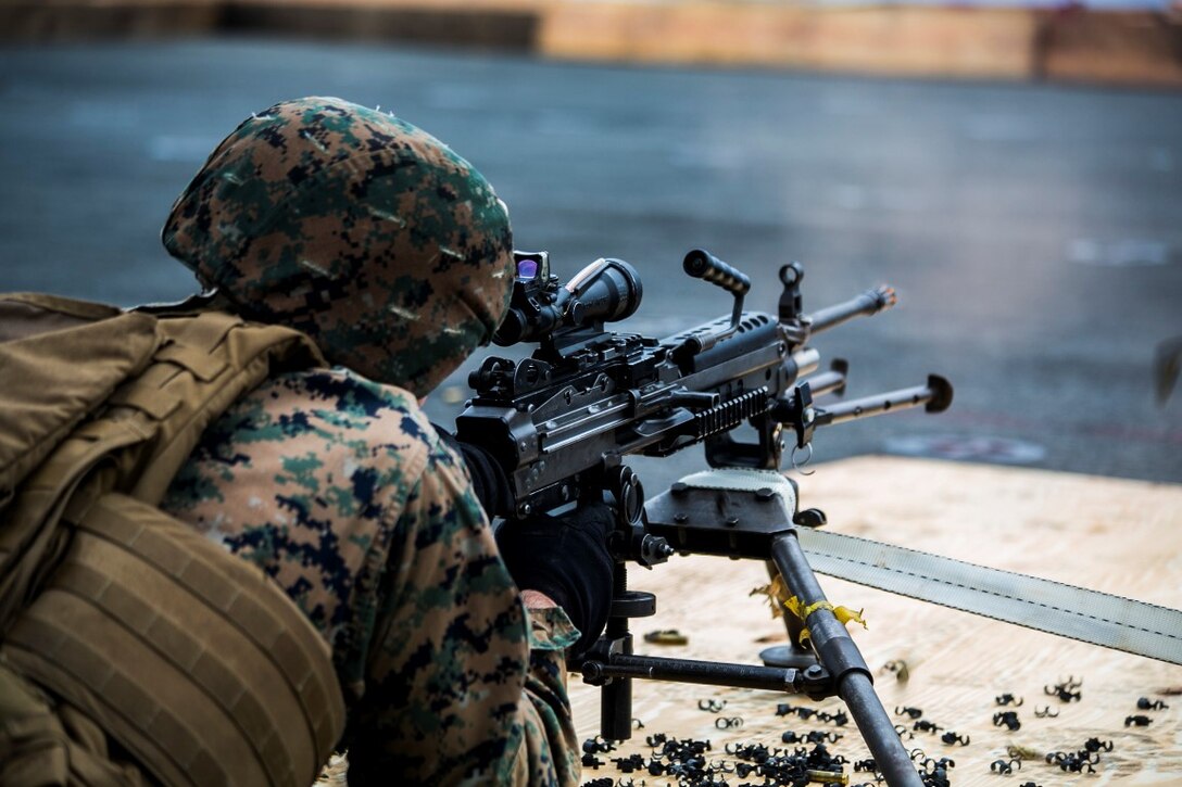 INDIAN OCEAN (Oct. 3, 2015) A U.S. Marine with the Combined Anti-Armor Team, Weapons Company, Battalion Landing Team 3rd Battalion, 1st Marine Regiment, fires an M240B machine gun during a deck shoot aboard the amphibious assault ship USS Essex (LHD 2). The Marines practiced firing the machine gun to enhance their marksmanship on ship. The 15th MEU is currently deployed in the Indo-Asia-Pacific region to promote regional stability and security in the U.S. 7th Fleet area of operations. (U.S. Marine Corps photo by Sgt. Anna Albrecht/ Released)