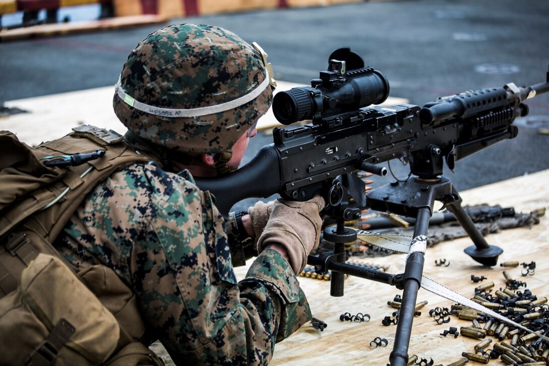 INDIAN OCEAN (Oct. 3, 2015) A U.S. Marine with the Combined Anti-Armor Team, Weapons Company, Battalion Landing Team 3rd Battalion, 1st Marine Regiment, fires an M240B machine gun during a deck shoot aboard the amphibious assault ship USS Essex (LHD 2). The Marines practiced firing the machine gun to enhance their marksmanship on ship. The 15th MEU is currently deployed in the Indo-Asia-Pacific region to promote regional stability and security in the U.S. 7th Fleet area of operations. (U.S. Marine Corps photo by Sgt. Anna Albrecht/ Released)