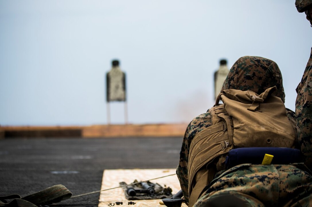 INDIAN OCEAN (Oct. 3, 2015) U.S. Marine Lance Cpl. Anthony Presley fires an M240B machine gun during a deck shoot aboard the amphibious assault ship USS Essex (LHD 2). Presley is a gunner with the Combined Anti-Armor Team, Weapons Company, Battalion Landing Team 3rd Battalion, 1st Marine Regiment. The Marines practiced firing the machine gun to enhance their marksmanship on ship. The 15th MEU is currently deployed in the Indo-Asia-Pacific region to promote regional stability and security in the U.S. 7th Fleet area of operations. (U.S. Marine Corps photo by Sgt. Anna Albrecht/ Released)