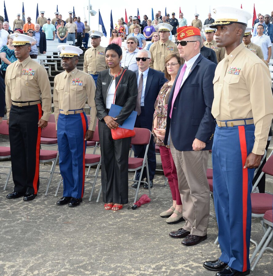 Installation officials, Marines, civilian-Marines and personnel from Marine Corps Logistics Base Albany’s tenant commands gather for a morning of pageants, Corps' history and cake-cutting in celebration of the Marine Corps’ 240th birthday, here, Nov. 3. The annual commemoration, which was held at the Amphitheater in Boyett Park/Covella Pond, featured Marines dressed in an array of uniforms and carrying weapons from specific eras, past to present, during a narration of the Marine Corps’ 240-year history. Col. James C. Carroll III, commanding officer, MCLB Albany, cut the traditional birthday cake and presented a slice to the installation’s oldest serving Marine present at the ceremony, Lt. Col. Walter Wilkie, who passed it to the youngest Marine present, Lance Cpl. Alandre Brown. The passing of the cake from the oldest to the youngest Marine symbolizes the passing of history and traditions to the next generation.