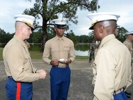 Installation officials, Marines, civilian-Marines and personnel from Marine Corps Logistics Base Albany’s tenant commands gather for a morning of pageants, Corps' history and cake-cutting in celebration of the Marine Corps’ 240th birthday, here, Nov. 3. The annual commemoration, which was held at the Amphitheater in Boyett Park/Covella Pond, featured Marines dressed in an array of uniforms and carrying weapons from specific eras, past to present, during a narration of the Marine Corps’ 240-year history. Col. James C. Carroll III, commanding officer, MCLB Albany, cut the traditional birthday cake and presented a slice to the installation’s oldest serving Marine present at the ceremony, Lt. Col. Walter Wilkie, who passed it to the youngest Marine present, Lance Cpl. Alandre Brown. The passing of the cake from the oldest to the youngest Marine symbolizes the passing of history and traditions to the next generation.