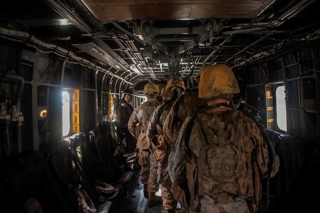 Marines with 5th Air Naval Gunfire Liaison Company practice exiting a CH-53E Super Stallion helicopter on Camp Hansen, Okinawa, Japan, Oct. 24. The Marines participated in the ANGLICO basic course, which included the loading and unloading of helicopters, setting-up perimeter security, coordinating artillery fire, naval gunfire and close air support. 5th ANGLICO is with III Marine Expeditionary Force Headquarters Group, III MEF.