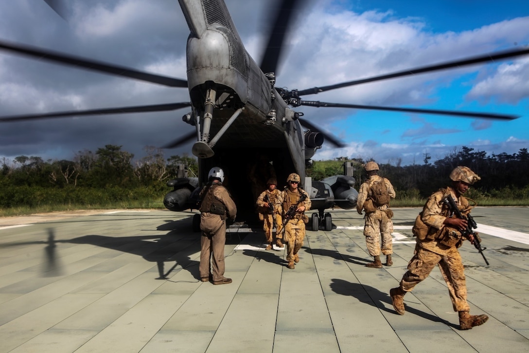 Marines with 5th Air Naval Gunfire Liaison Company practice exiting a CH-53E Super Stallion helicopter on Camp Hansen, Okinawa, Japan Oct. 24. The Marines participated in the ANGLICO basic course, which, included the loading and unloading of helicopters, setting-up perimeter security, coordinating artillery fire, naval gunfire and close air support. The Marines are with 5th ANGLICO is with, III Marine Expeditionary Force Headquarters Group, III MEF.