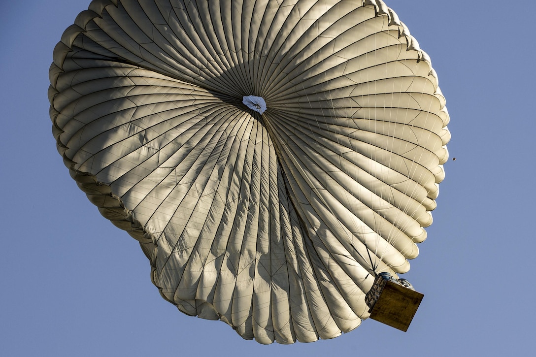 A container delivery system parachutes toward the drop zone during Aviation Detachment 16-1 on Powidz Air Base, Poland, Oct. 27, 2015. U.S. Air Force photo/Senior Airman Damon Kasberg
