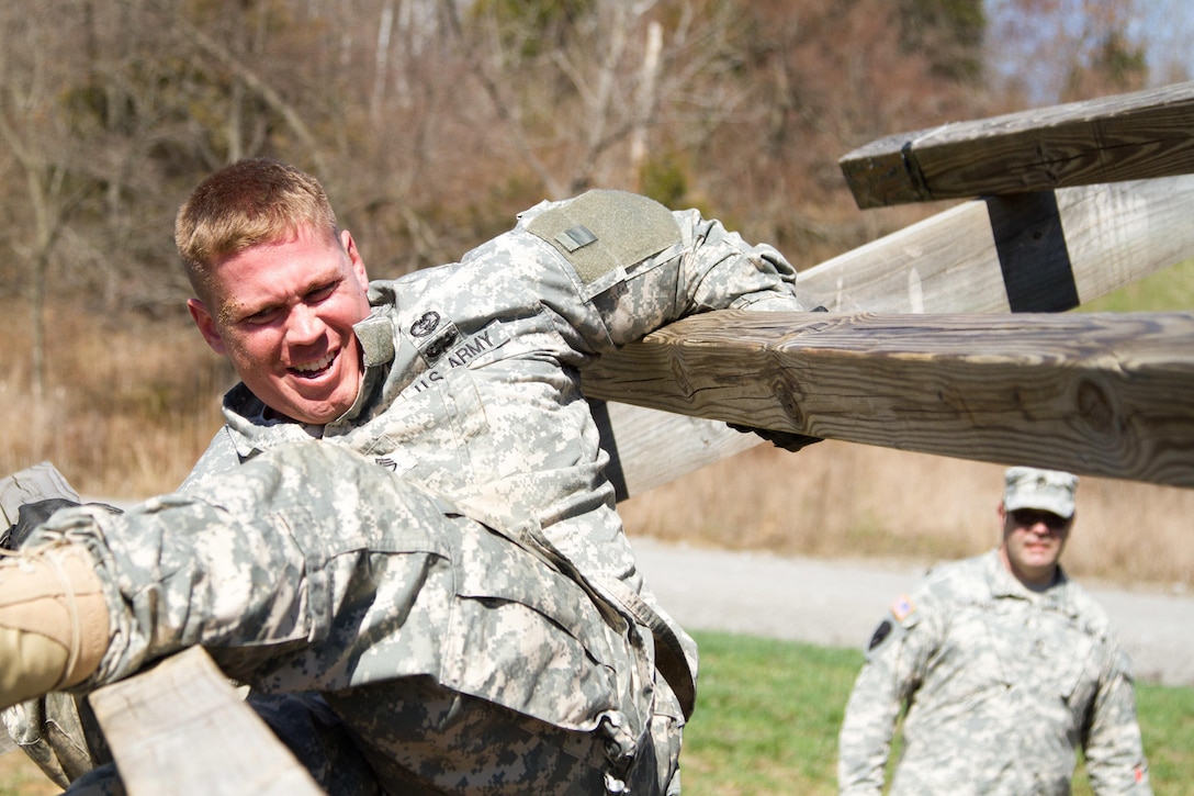 Staff Sgt. Andrew Fink, 409th Area Support Medical Company, 307th Medical Brigade, 807th Medical Command, a native of Cook, Minn., and a candidate in the 807th Medical Command Best Warrior competition, picks his way through "The Weaver" obstacle at the Wendell H. Ford Training Center near Greenville, Ky. March 23. Fink won the 807th Medical Command Best Warrior noncommissioned officer catagory.  He'll compete at the US Army Reserve Best Warrior competition this May.  (US Army Photo by Sgt. 1st Class Adam Stone)