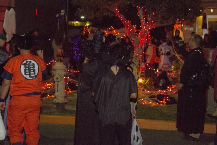 Station volunteers and orphans from Garden of Light Children’s Home in Hatsukaichi, Hiroshima Prefecture, Japan, trick-or-treat during a Halloween event at Marine Corps Air Station Iwakuni, Oct. 31, 2015. During their visit, 50 station volunteers escorted 15 orphans to a haunted house operated by Marines from Marine Wing Support Squadron 171, enjoyed bonding over dinner and trick-or-treating around the air station. While trick-or-treating, visitors and volunteers could see how station residents celebrate the spooky holiday, from the eccentric costumes to the decorated houses.