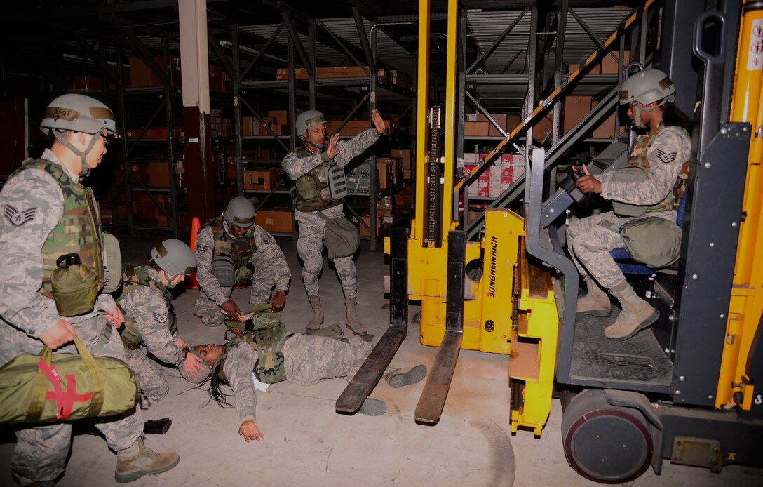 Members of the 51st Logistics Readiness Squadron's materials management flight begin performing Self-Aid Buddy Care on an exercise victim Nov. 2, 2015, at Osan Air Base, Republic of Korea. The skills included in SABC are part of enhancing skills as part of the readiness exercise Vigilant Ace 16. (U.S. Air Force photo/Staff Sgt. Benjamin Sutton)