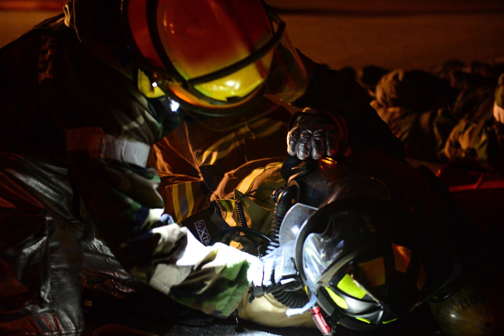 A firefighter from the 51st Civil Engineer Squadron performs simulated first aid on a fellow firefighter in the aftermath of a mock building fire during Vigilant Ace 16 at Osan Air Base, Republic of Korea, Nov. 3, 2015. The exercise tests the linkage between operational-level planners and tactical units, including increased ROK air force participation. (U.S. Air Force photo/Staff Sgt. Amber Grimm)