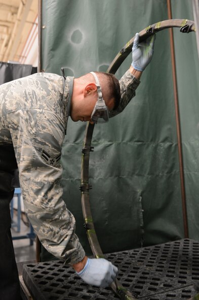 Airman 1st Class Bernard Moskalis, 56th Equipment Maintenance Squadron nondestructive inspection technician, performs a florescent penetrant inspection on an F-16 Fighting Falcon engine sink ring at Luke Air Force Base, Arizona, Oct. 30, 2015. (U.S. Air Force photo by Senior Airman James Hensley)