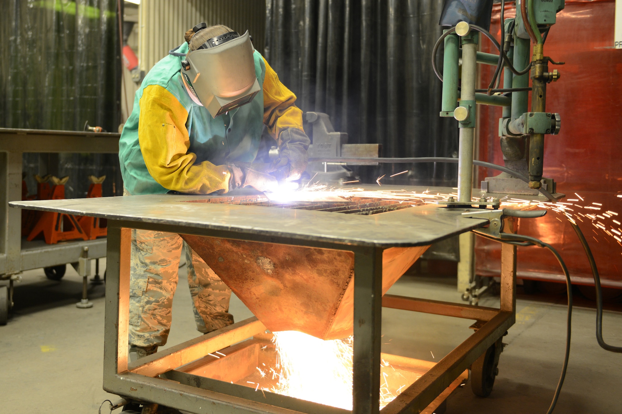 Senior Airman Rachel White, 56th Equipment Maintenance Squadron metals technology journeyman, uses a plasma cutter on a piece of scrap metal at Luke Air Force Base, Arizona, Oct. 30, 2015. Metals technology technicians work mostly on aerospace ground equipment and case by case equipment. (U.S. Air Force photo by Senior Airman James Hensley)