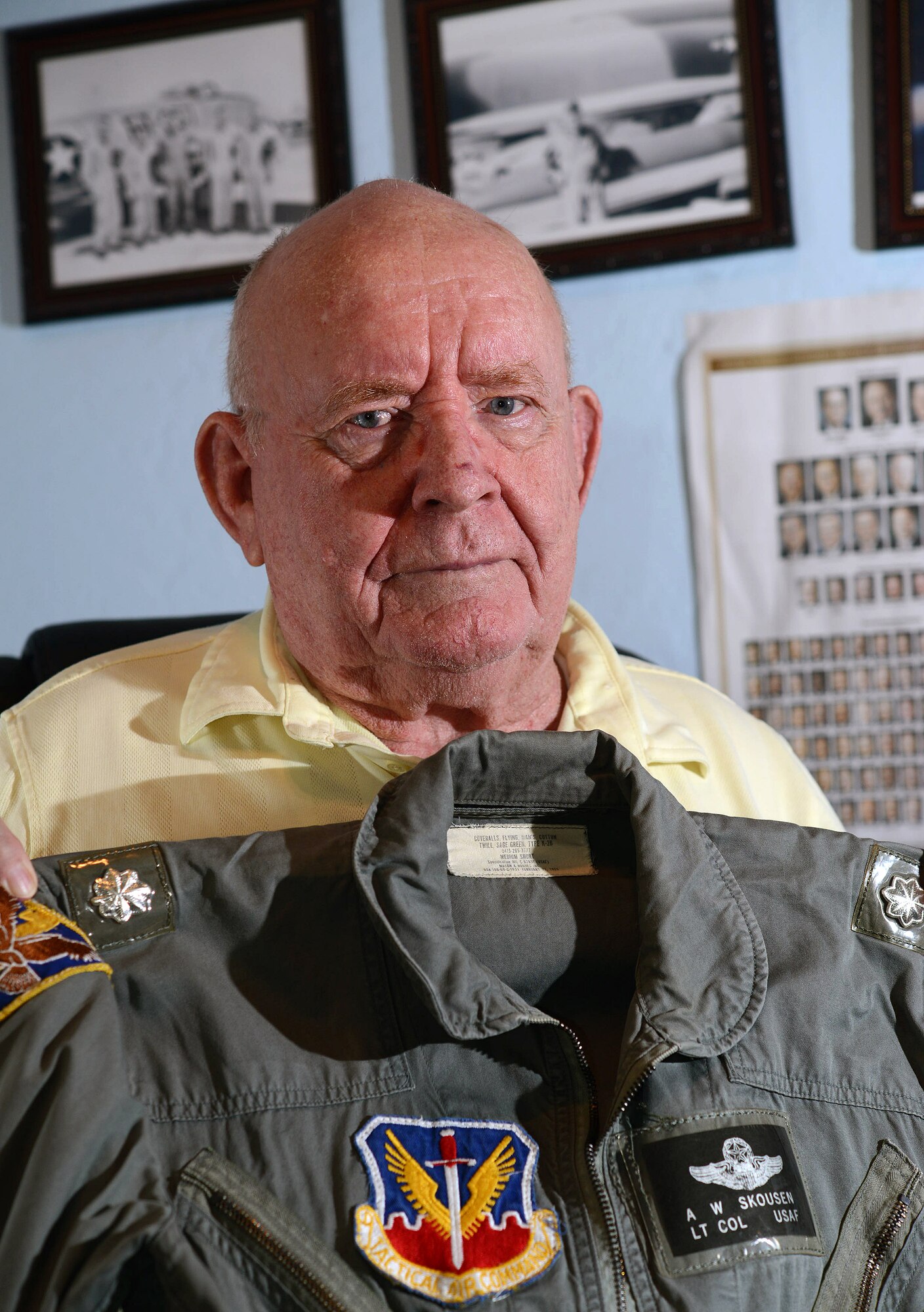 Retired Lt. Col. Alma Skousen shows off his flight suit October 30, 2015, in his Mesa, Ariz., home. Skousen flew combat missions in the Korean and Vietnam wars, was awarded the Distinguished Flying Cross for acts of heroism and extraordinary achievement while participating in an aerial flight. Skousen ended his flying career with more than 6,000 flying hours. (U.S. Air Force photo by Tech. Sgt. Timothy Boyer)