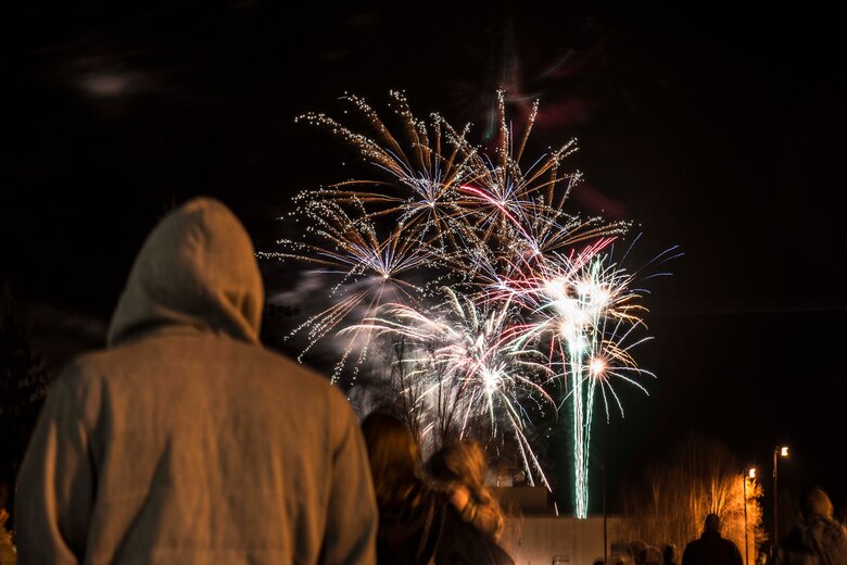 Icemen and their families watch fireworks during the Fall Festival on Oct. 28, 2015, at Eielson Air Force Base, Alaska. The 354th Force Support Squadron puts on a 4th of July-scale fireworks show during the fall because the summer months have such extended hours of sunlight. (U.S. Air Force photo by Staff Sgt. Joshua Turner/Released)