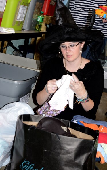 Madeline Kraft, Shaw Air Force Base Attic assistant coordinator, sorts through bags of donated clothing items Oct. 29, 2015, at SAFB, S.C. Volunteers sort through thousands of donated clothing and household items each week that are then put out at the Attic for eligible personnel to shop. The Attic, open to all enlisted personnel E-5 and below, allows Team Shaw members and their families to take home up to 25 items weekly, free of charge. (U.S. Air Force photo by Staff Sgt. Laura LV Claypool/Released) 
