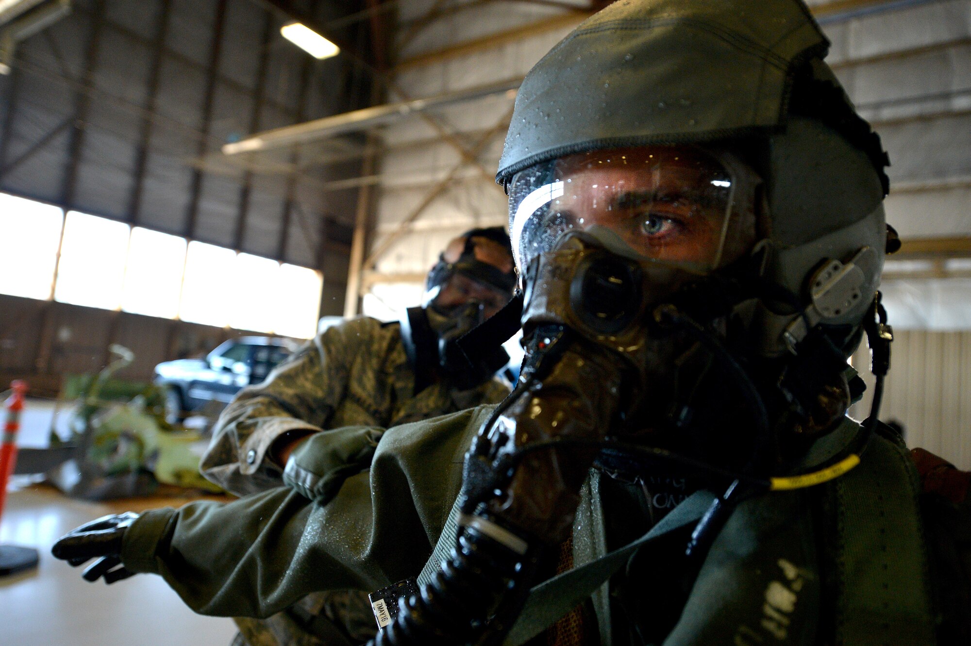 U.S. Air Force 1st Lt. Chris Brown, 77th Fighter Squadron F-16CM Fighting Falcon pilot, is patted down with simulated decontamination powder by an 20th Operations Support Squadron aircrew flight equipment specialist during AFE decontamination training at Shaw Air Force Base, S.C., Oct. 30, 2015. The AFE Airmen use powder and sprays to ensure the contaminate is mitigated and the process of removing equipment and clothing is efficient and safe. (U.S. Air Force photo by Senior Airman Diana M. Cossaboom/Released)