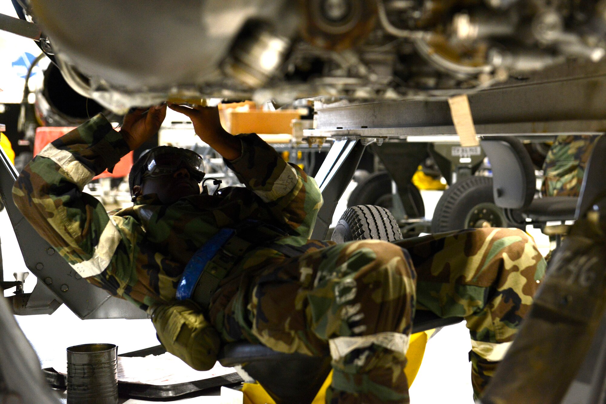 A 20th Component Maintenance Squadron Airman works on an F-16CM Fighting Falcon engine during operational readiness exercise Weasel Victory 16-02 at Shaw Air Force Base, S.C., Nov. 3, 2015. Team Shaw Airmen adapted to Mission Oriented Protective Posture level conditions while continuing to perform their duties under simulated combat conditions. (U.S. Air Force photo by Airman 1st Class Christopher Maldonado/Released)