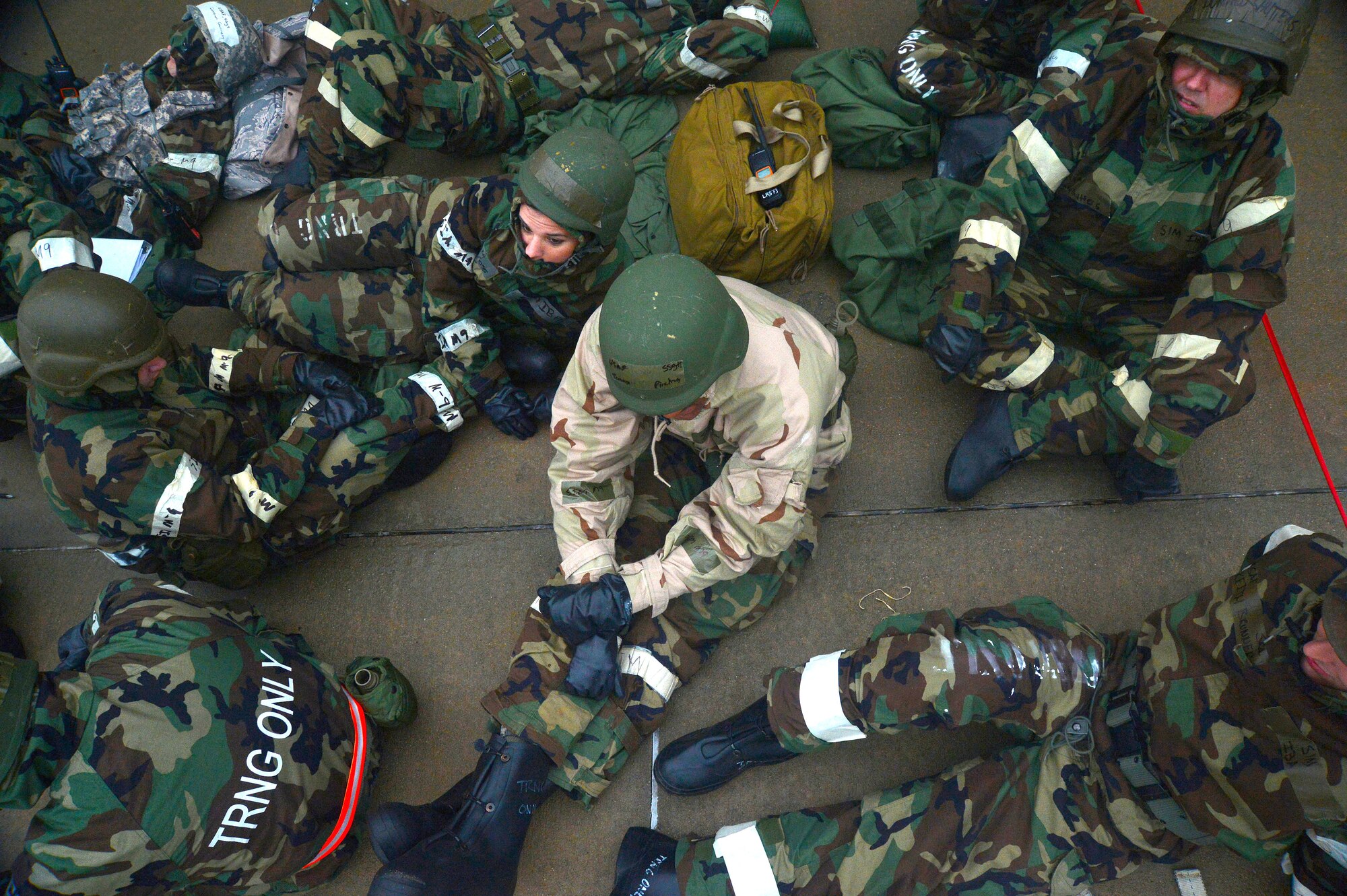 U.S. Air Force Airmen sit in a shelter during operational readiness exercise Weasel Victory 16-02 at Shaw Air Force Base, S.C., Nov. 2, 2015. An ORE tests the combat capabilities of the 20th Fighter Wing through a variety of simulated events stressing the employment of simulated forces, the sustainment of support during contingency operations, and the ability to meet Air Force standards for mission continuity. (U.S. Air Force photo by Senior Airman Michael Cossaboom/Released)