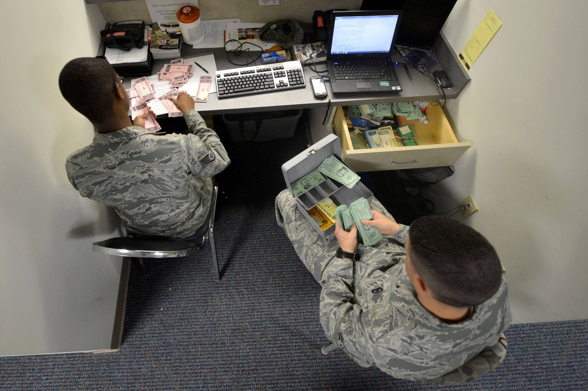 U.S. Air Force Staff Sgt. Isaiah Resto and Airman 1st Class Chad Robertson, 20th Comptroller Squadron financial technicians, count simulated money during operational readiness exercise Weasel Victory 16-02 at Shaw Air Force Base, S.C., Nov. 2, 2015. OREs are integrated into training to ensure Airmen are always combat ready. (U.S. Air Force photo by Senior Airman Michael Cossaboom/Released)