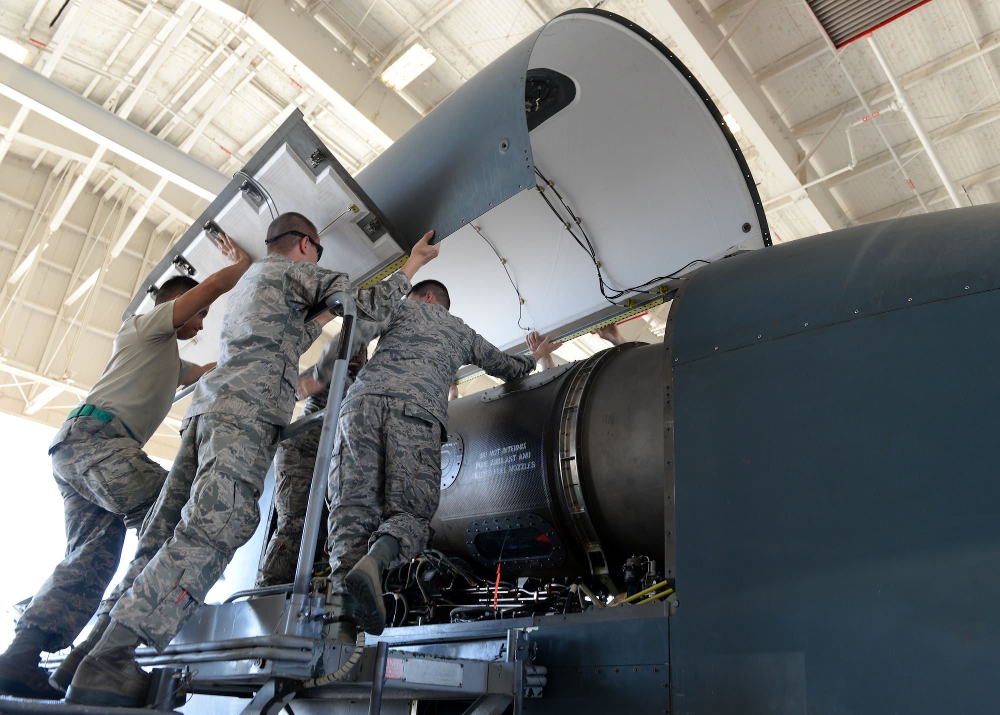 Airmen from the 12th Aircraft Maintenance Unit installs an engine cover panel on a RQ-4 Global Hawk Oct. 29, 2015, at Beale Air Force Base, California. The aircraft being worked on recently arrived at Beale to conduct a non-destructive inspection. Beale is used as the maintenance depot for the U.S. Air Force’s RQ-4 fleet. (U.S. Air Force photo by Airman 1st Class Ramon A. Adelan)